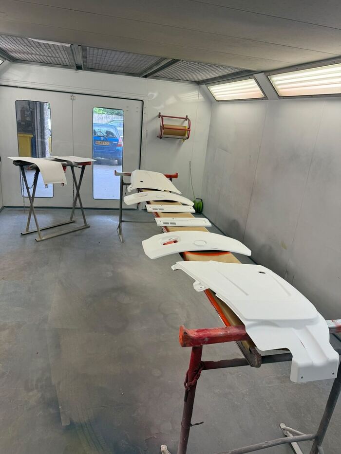 The same Kubota panels laid out on trestles, now in light primer