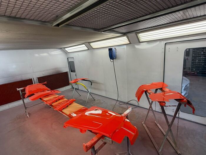 The same Kubota panels finished in gloss orange on stands in the booth